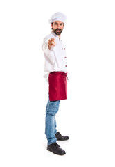 Chef pointing to the front over white background