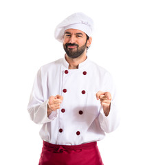 Chef pointing to the front over white background