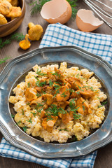 scrambled eggs with chanterelles and fresh dill, top view