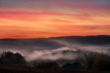 Sunset over a valley during autumn