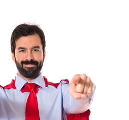 Businessman dressed like superhero pointing to the front