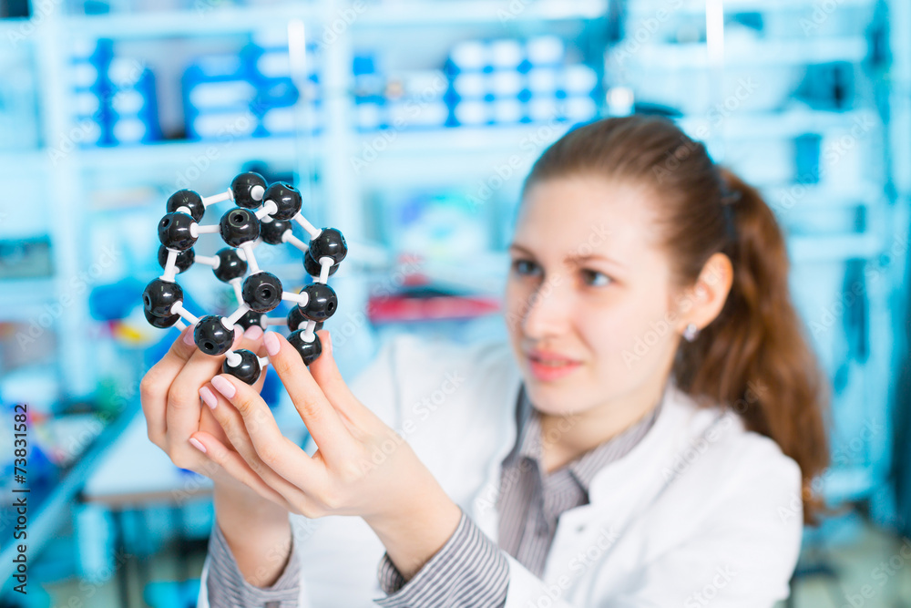 Wall mural young woman scientist working at the laboratory.