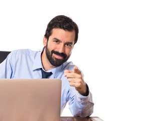 Businessman pointing to the front over white background