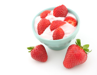 Fresh strawberry with yogurt in a glass isolated on white