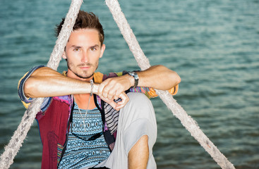 fashion handsome man relaxing on beach