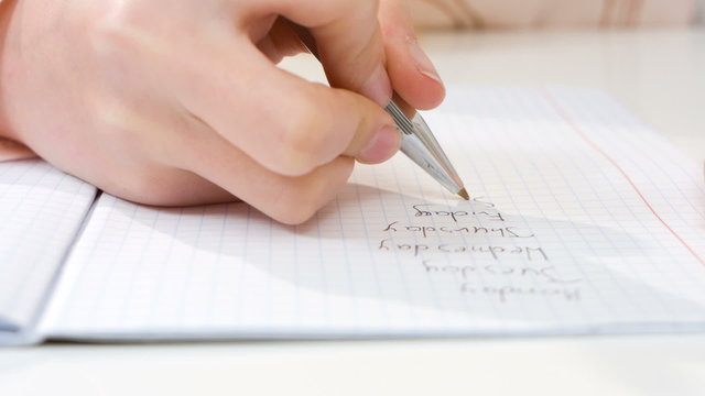 Child writing homework closeup 