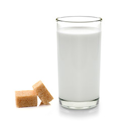 Fototapeta na wymiar glass of milk and cubes of cane sugar isolated on white backgrou