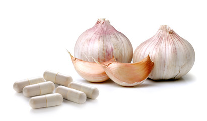 garlic and  pills capsule isolated on white background