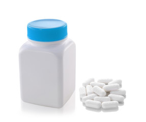 pills out of bottle on white background