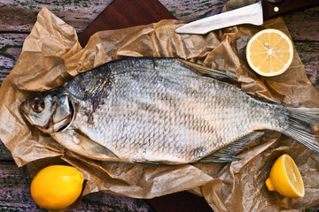 Sun dried fish on the purple wooden background