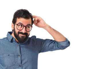 Young hipster man thinking over white background