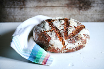 Loaf of rye artisan sourdough bread, rustic kitchen