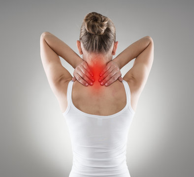 Injured neck. Young female suffering from spine disease.