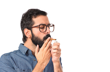 Young hipster man smoking over white background