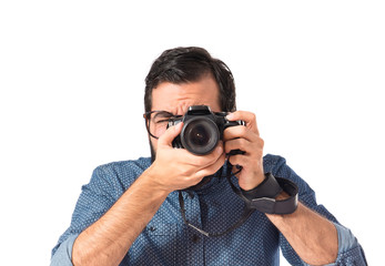 Obraz premium Young hipster man photographing over white background