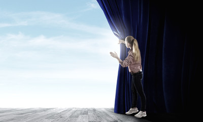 Girl opening curtain