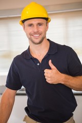 Smiling construction worker giving thumbs up