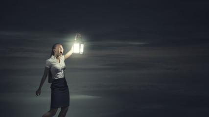 Businesswoman with lantern