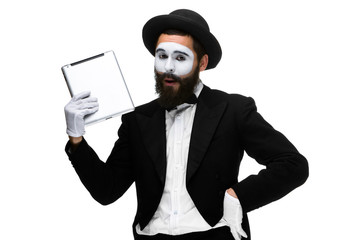 Man with a face mime working on  laptop