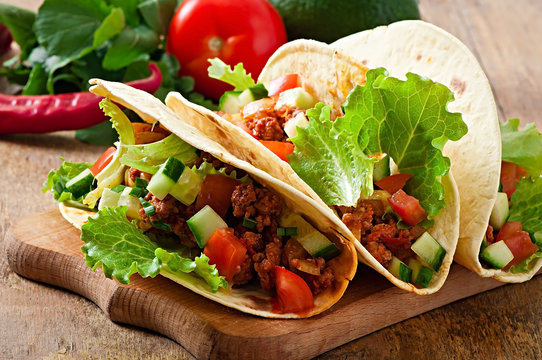 Mexican tacos with meat, vegetables and cheese