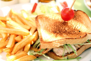 Chicken sandwich with French fries and salad
