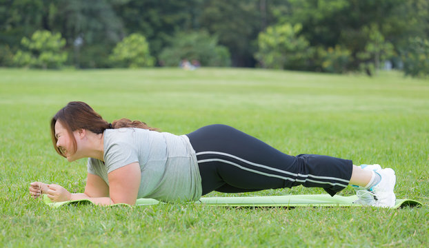 obese women planking on grass