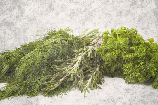 parsley, dill and rosemary on background