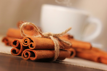 Cinnamon and beverage cup on wooden table series - 3