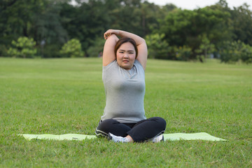 obese women yoga on grass