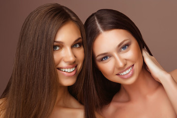 Portrait of two Beautiful Women with Long Hair and Clean Skin