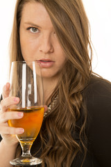 Woman holding wine glass serious look into camera