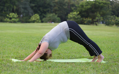 Fototapeta na wymiar obese women yoga on grass