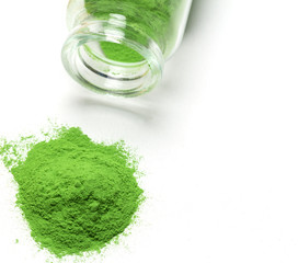 Green powder poured out from glass bottle