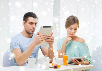 couple with tablet pc having breakfast