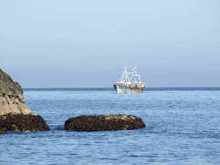 Fishing cutter in front of clear blue sky