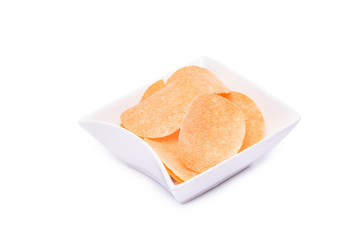 crisps potato chips on white plate Isolated