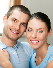 Young happy smiling attractive couple at home