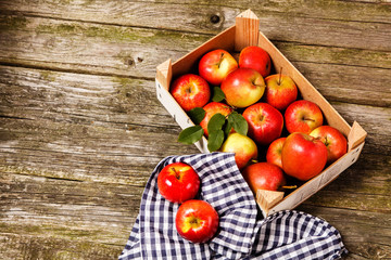 Fresh red apples on wooden table