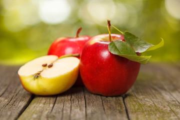 Fresh red apples on wooden table