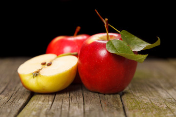 Fresh red apples on wooden table