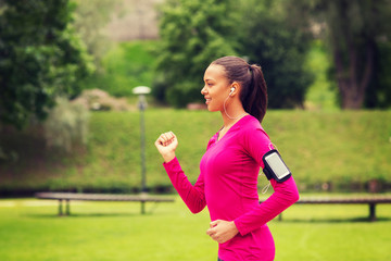 smiling young woman running outdoors