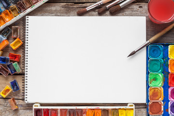 Set of watercolor paints,  brushes for painting and blank white