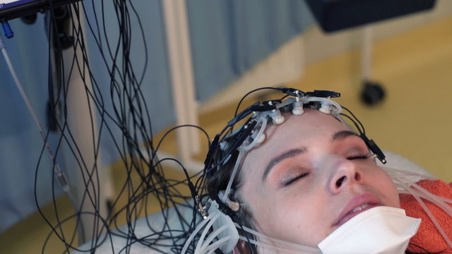 Woman in sleep having brain scan in hospital