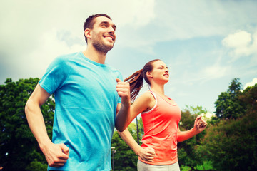 smiling couple running outdoors