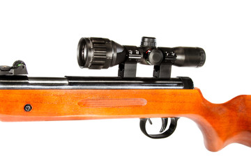 air rifle with a telescopic sight and a wooden butt
