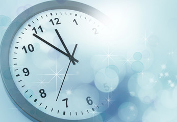 Fototapeta na wymiar Clock and blue blurred background. New Year time