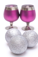 Glasses and silver baubles on white  background