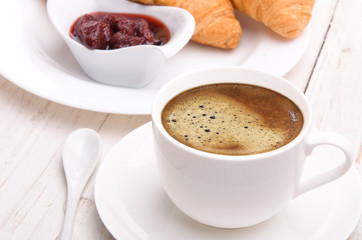 Cup of coffee with croissants.