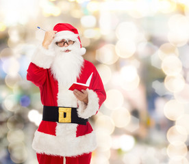 man in costume of santa claus with notepad