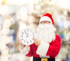 man in costume of santa claus with clock